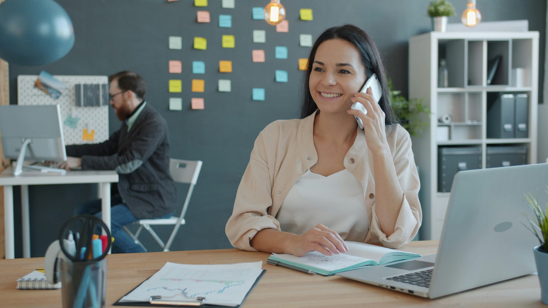 A public-sector professional on the phone at her desk