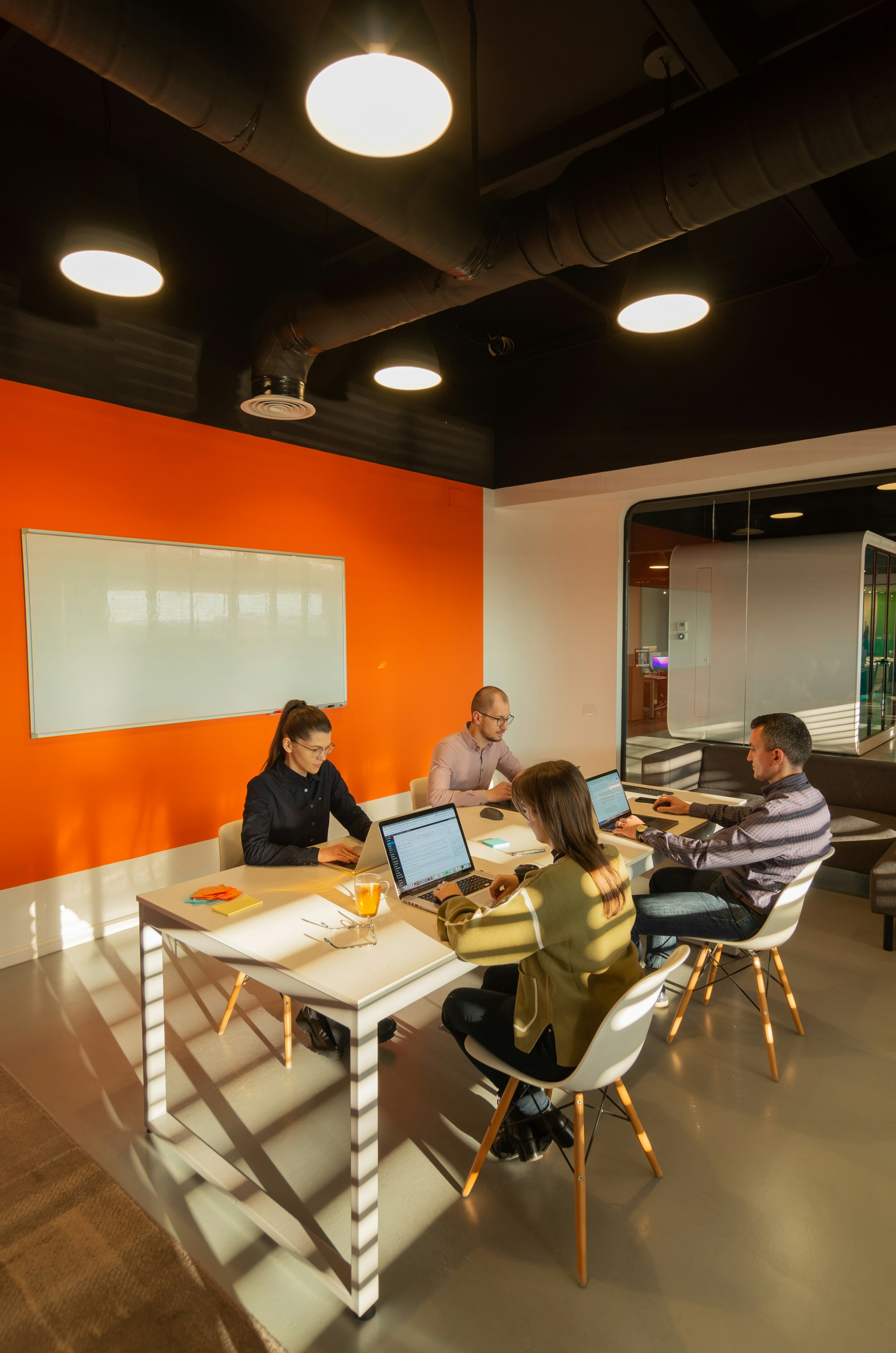 An Infomax delivery team working together at laptops